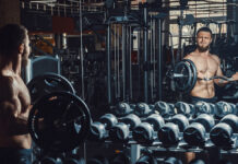 Как быстро увидеть результаты от тренировок SportyHandsomeYoungManBodybuilderLiftingBarbellAndWorkingOn