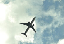 SemiSilhouetteOfJetPlaneFlyingUnderABlueSky