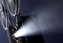 Путин наградил режиссера Лопушанского орденом за заслуги в культуре и искусстве Angled16mmMovieProjectorProjectingImagesThroughSmokyBackgroundWith