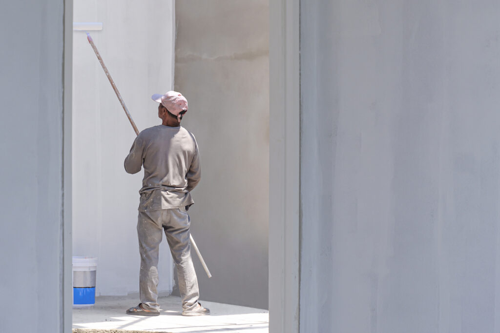 Кадр 1 человек в белом красит стену