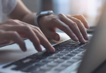 CloseUpImageOfWomanHandsTypingOnLaptopComputer