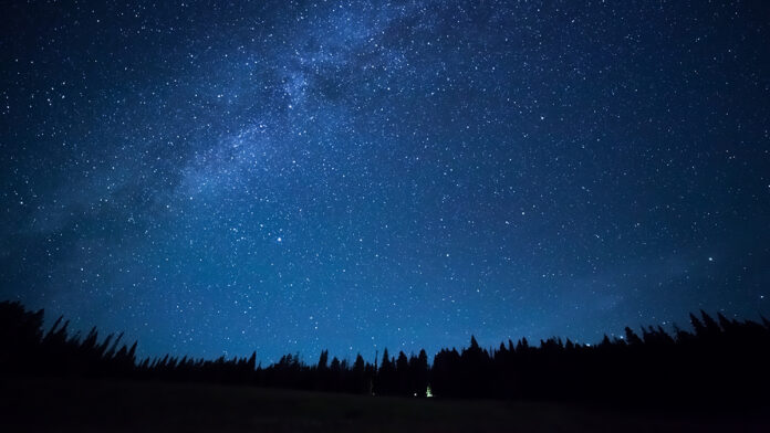 BlueDarkNightSkyWithManyStarsAboveFieldOf