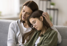 Как понять и поддержать подростка в период взросления CompassionateYoungMotherComfortingDepressedSadTeenGirlHuggingDaughter