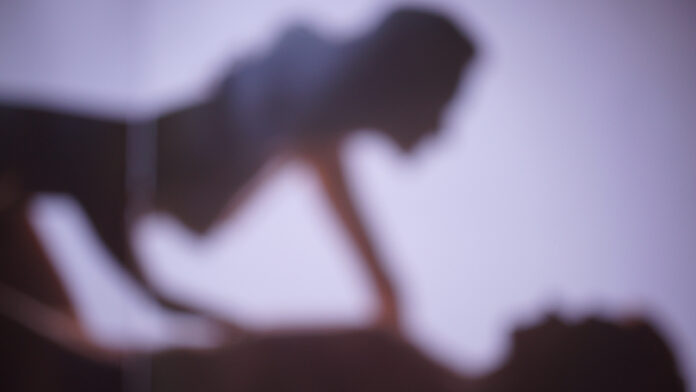 BlurredBackgroundSilhouettesOfACoupleInLoveAMan