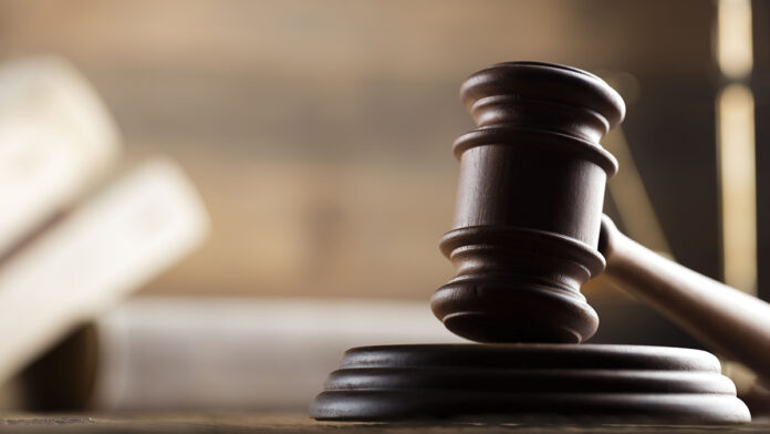 LawThemeMalletOfTheJudgeWoodenDeskScalesOf