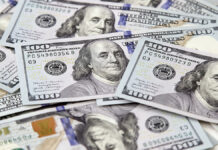 AmericanHundredDollarPaperMoneyLiesOnTheOfficeTable