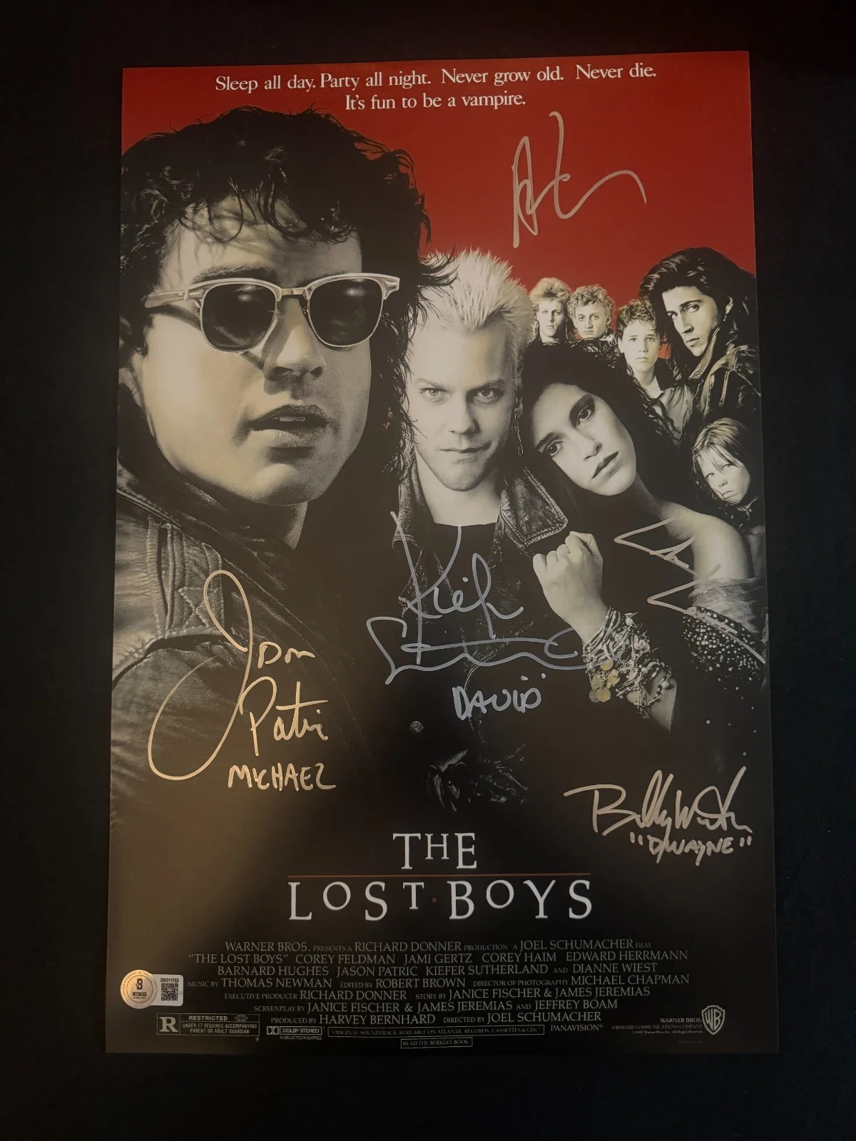 Jason Patric and Kiefer Sutherland — The Lost Boys cast signed (Names in Disc) 11x17 photo W/Beckett witnessed COA