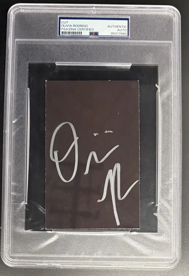 Olivia Rodrigo — Olivia Rodrigo Signed Autograph PSA/DNA Slabbed Encapsulated Cut Card COA Sour B