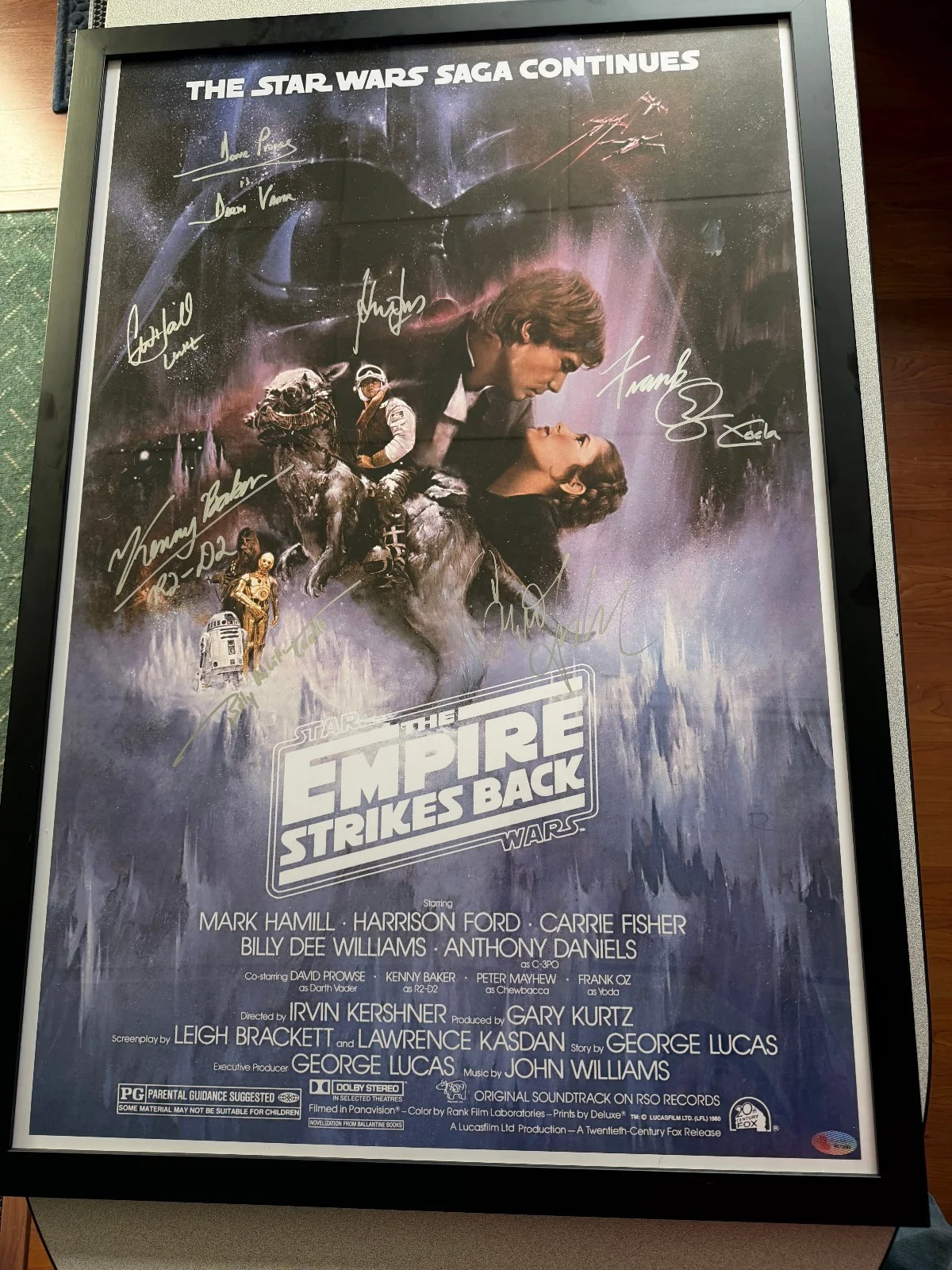 Williams, Oz, Prowse, Fisher, Ford, Hamill, Baker — Empire Strikes Back signed by 7 actors. 38"x26"