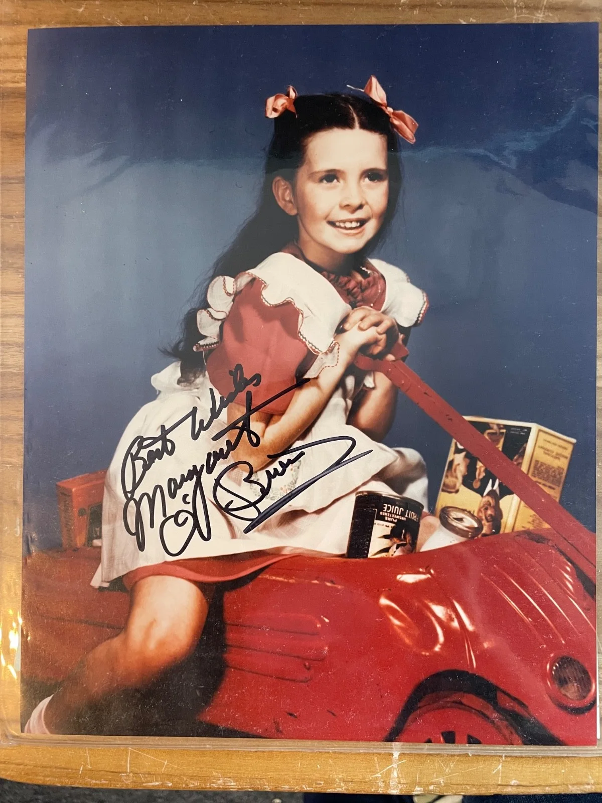 Margaret O'Brien — Signed Photograph, Margaret O'Brien on Red Wagon in White Pinafore