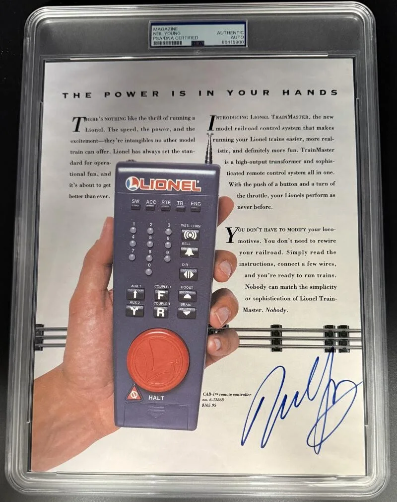 Neil Young — Neil Young Signed Autograph PSA/DNA Encapsulated Lionel Train Magazine Page
