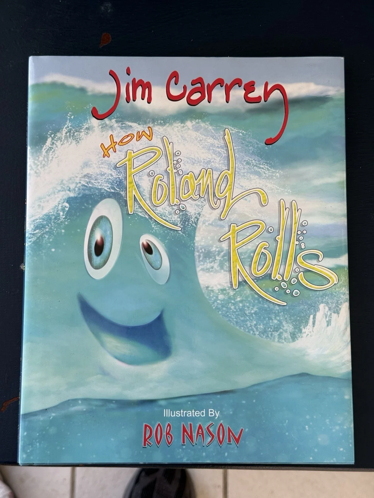Jim Carrey — Jim Carrey How Roland Rolls Signed Children's Book Hard Cover - Great Condition!
