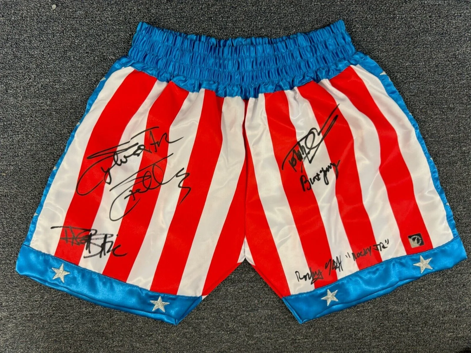 Sylvester Stallone and Cast — Sylvester Stallone, Shire & Cast Autographed ROCKY IV Trunks ASI Proof