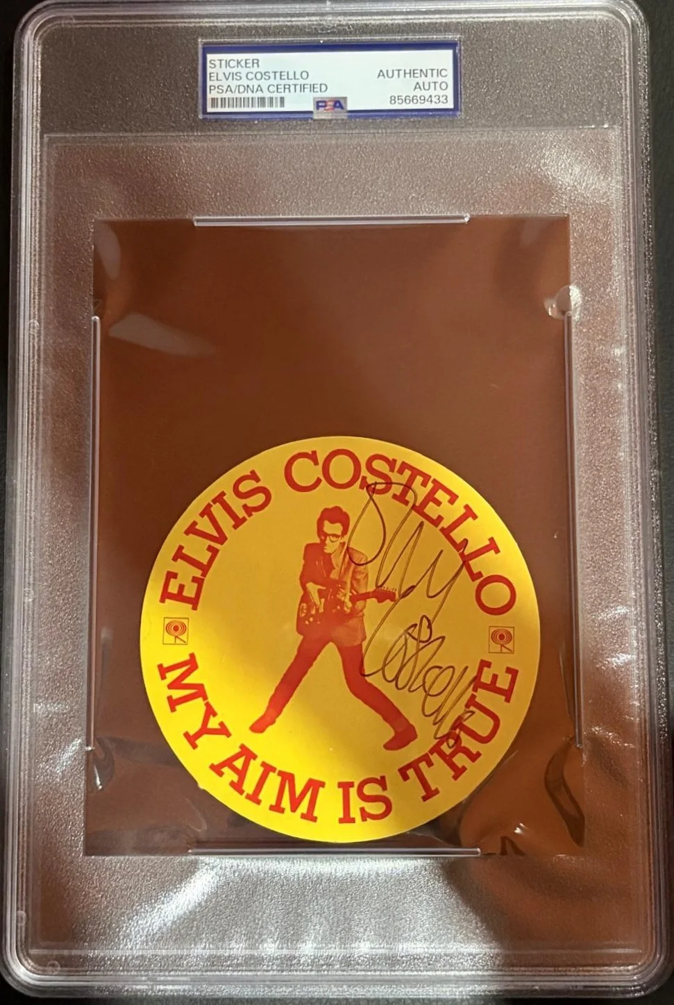 Elvis Costello — ELVIS COSTELLO SIGNED AUTOGRAPH STICKER ENCAPSULATED PSA RARE MY AIM IS TRUE