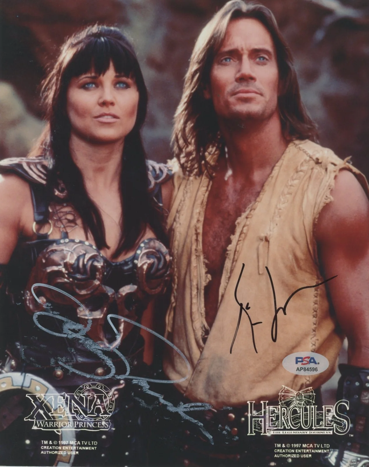 Kevin Sorbo & Lucy Lawless — Kevin Sorbo & Lucy Lawless Hercules Authentic Signed 8x10 Photo PSA/DNA #AP84596