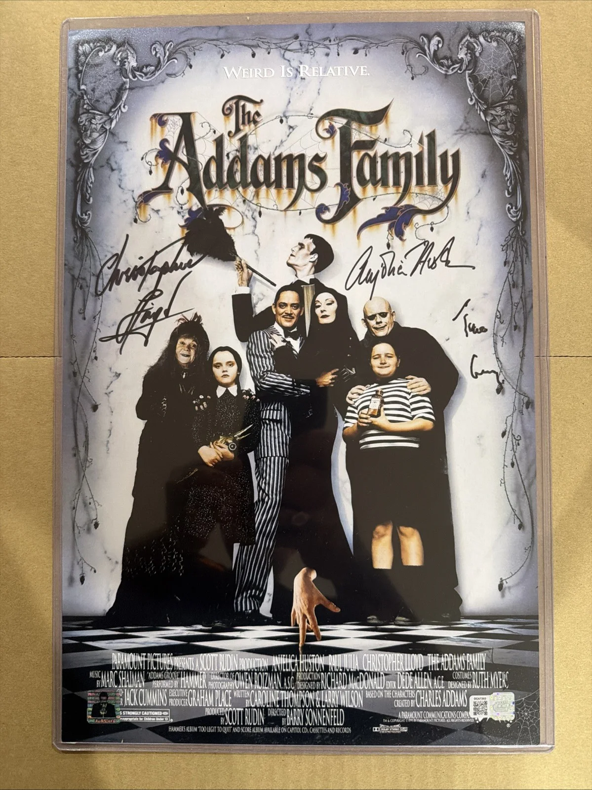 Anjelica Huston, Christopher Lloyd & Tim Curry — Addams Family Signed/Autographed 11x17. Huston, Lloyd & Curry. OCCM & Curry COA