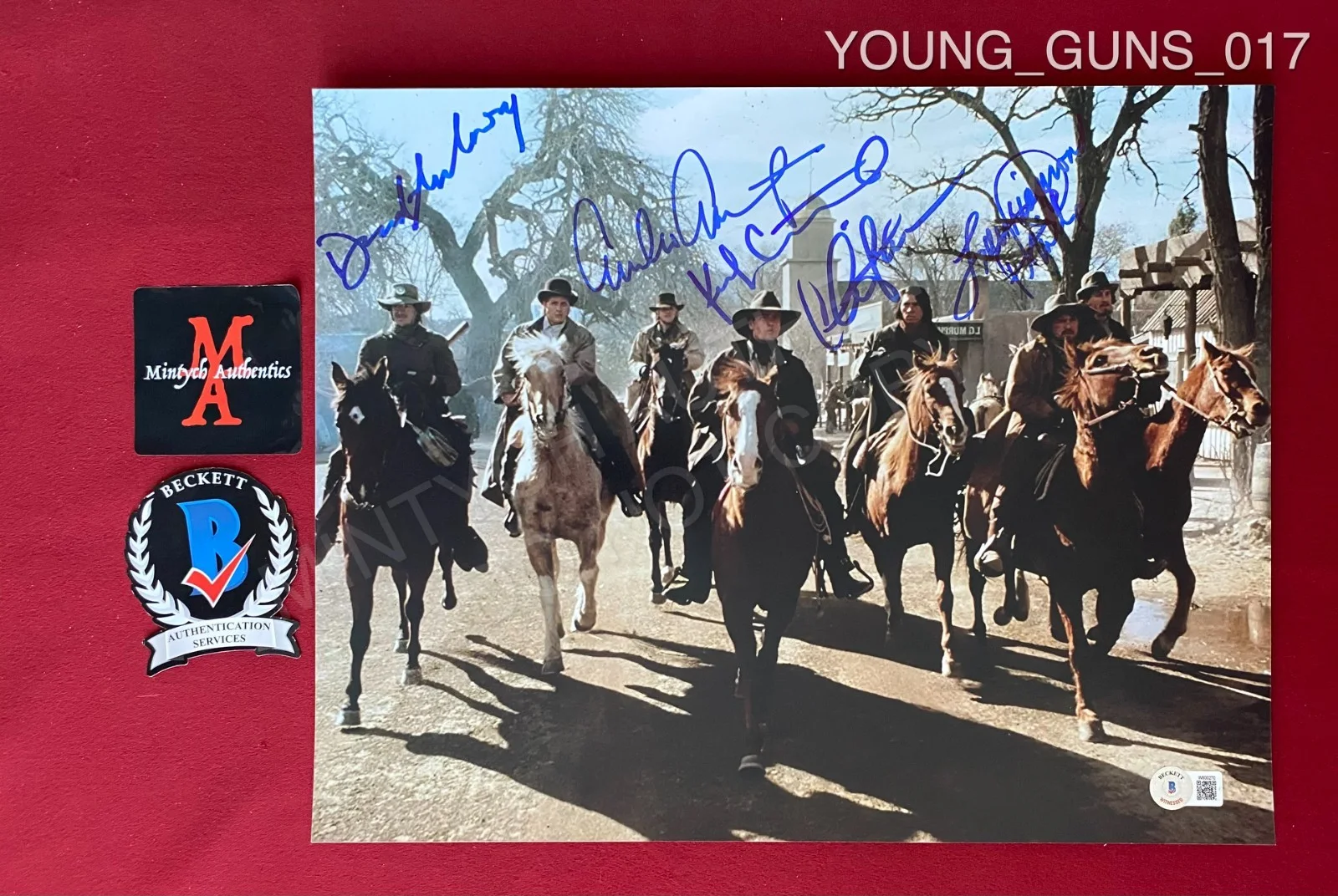 Dermot Mulroney, Emilio Estevez, Kiefer Sutherland, Charlie Shee — Young Guns cast signed 11x14 photo Beckett Sutherland Sheen Mulroney Estevez +1
