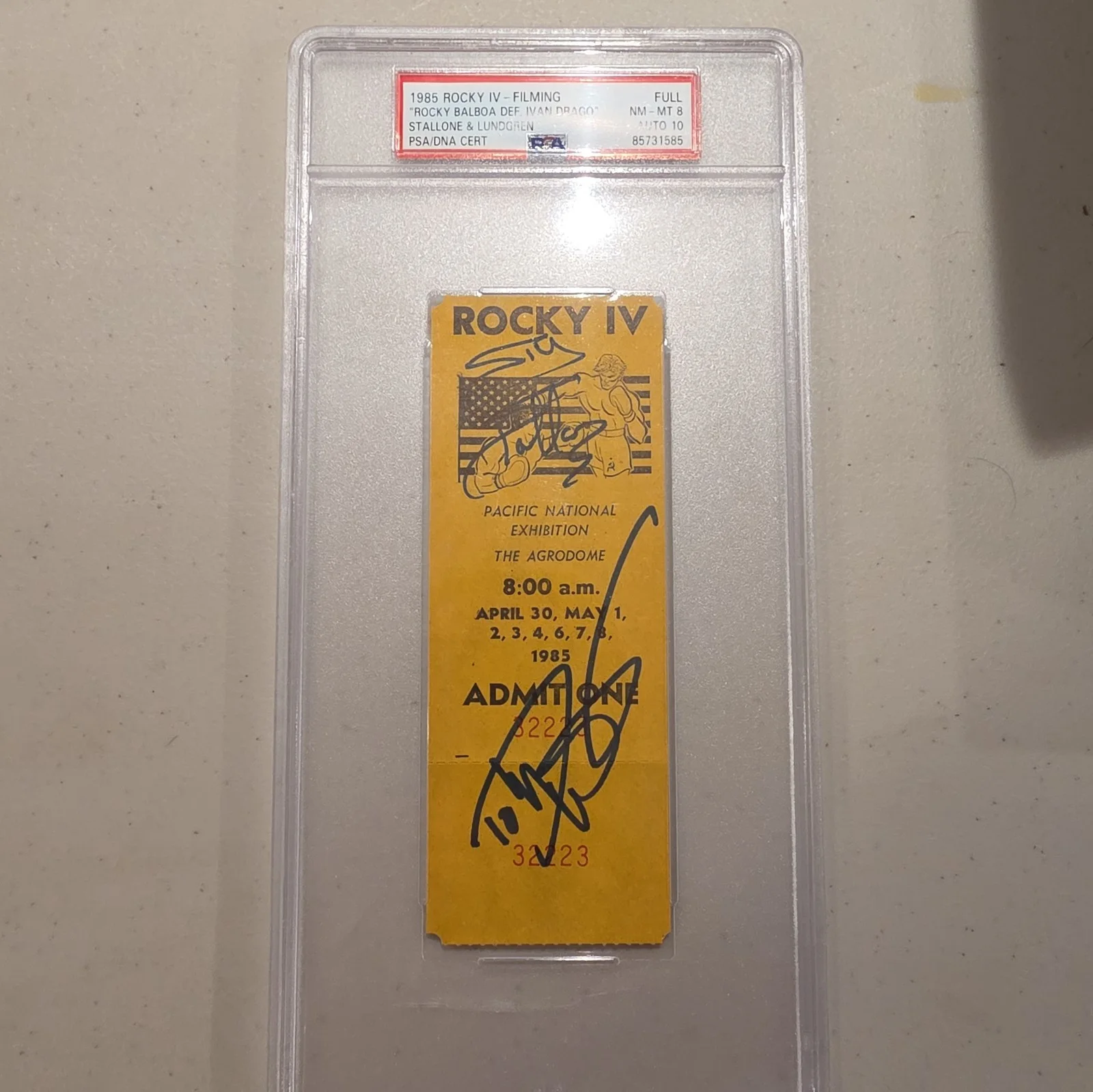 Sylvester Stallone & Dolph Lundgren — 1985 ROCKY IV Filming Ticket (PSA 8) & Autos (PSA 10) for Stallone & Lundgren