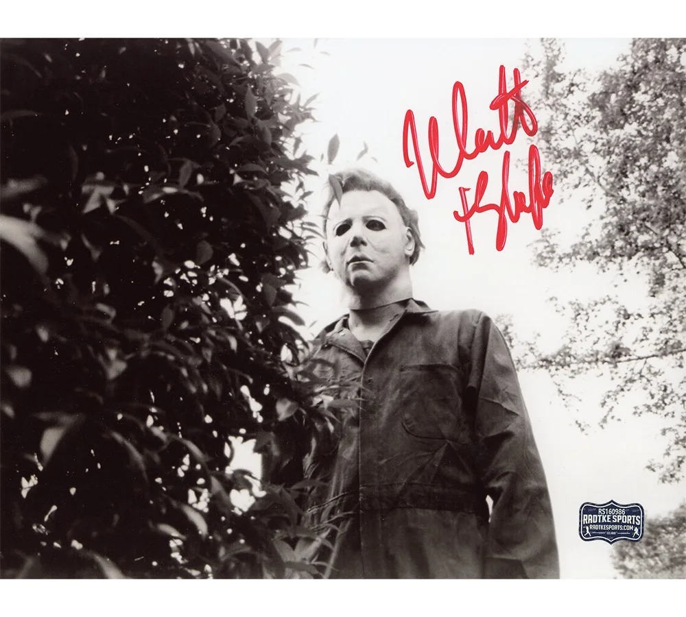 Nick Castle — Nick Castle Signed Halloween Unframed 8x10 Behind Bush Photo - "The Shape" Insc
