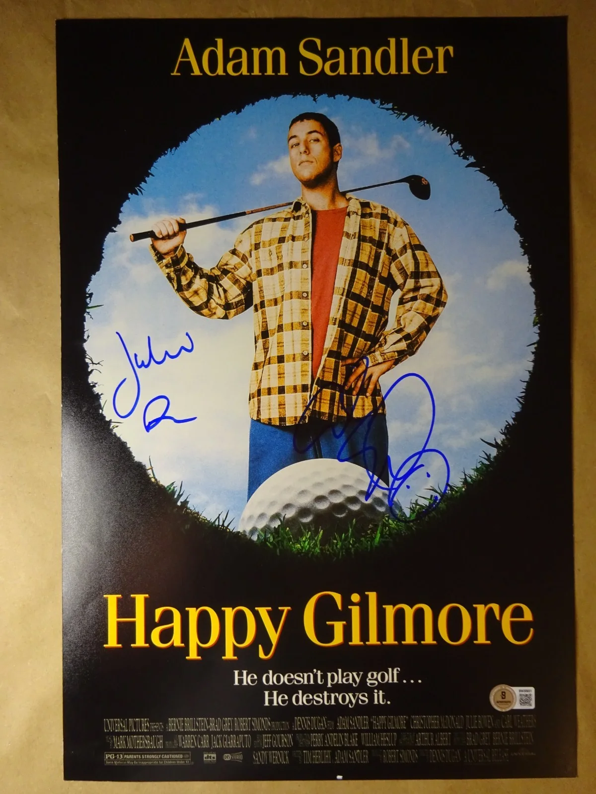 Adam Sandler and Julie Bowen — Signed Adam Sandler Julie Bowen Autographed 12"x18" Happy Gilmore Photo BAS COA