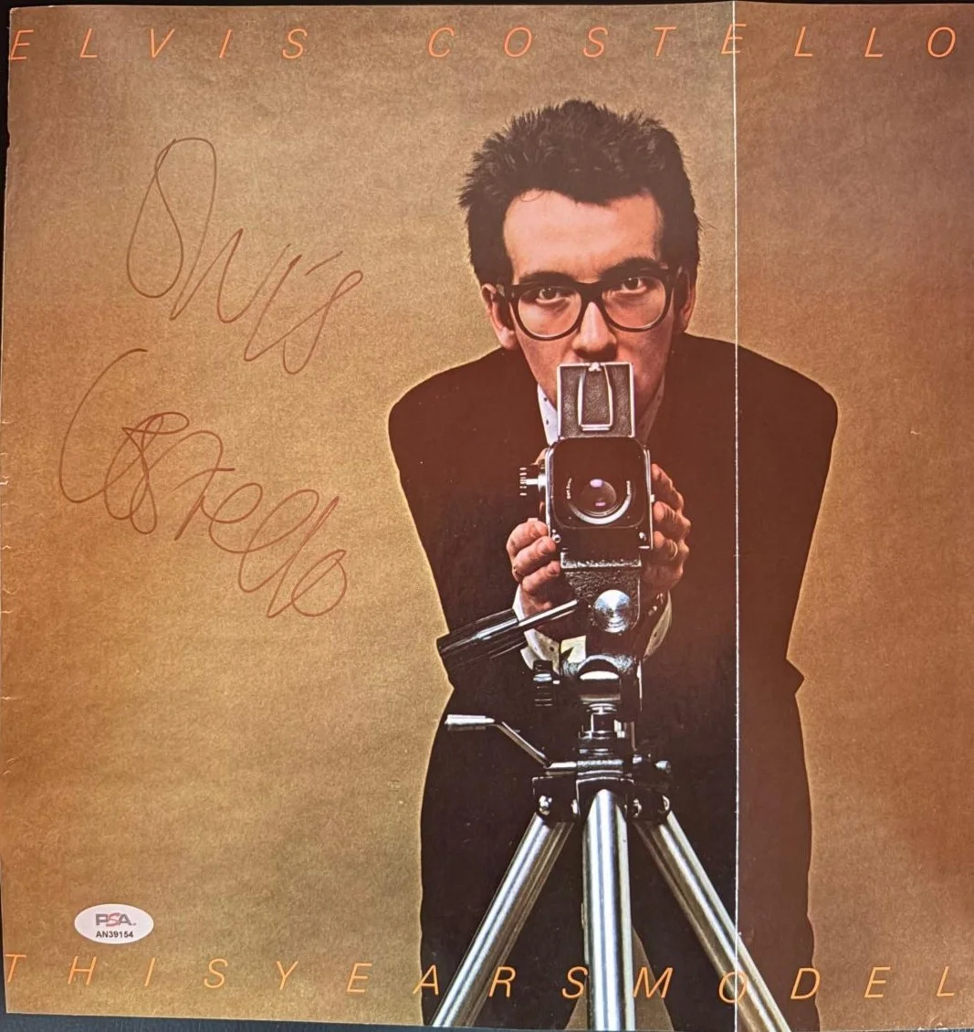 Elvis Costello — ELVIS COSTELLO SIGNED AUTOGRAPHED 11X14 ALBUM FLAT PAGE FULL NAME VINTAGE PSA