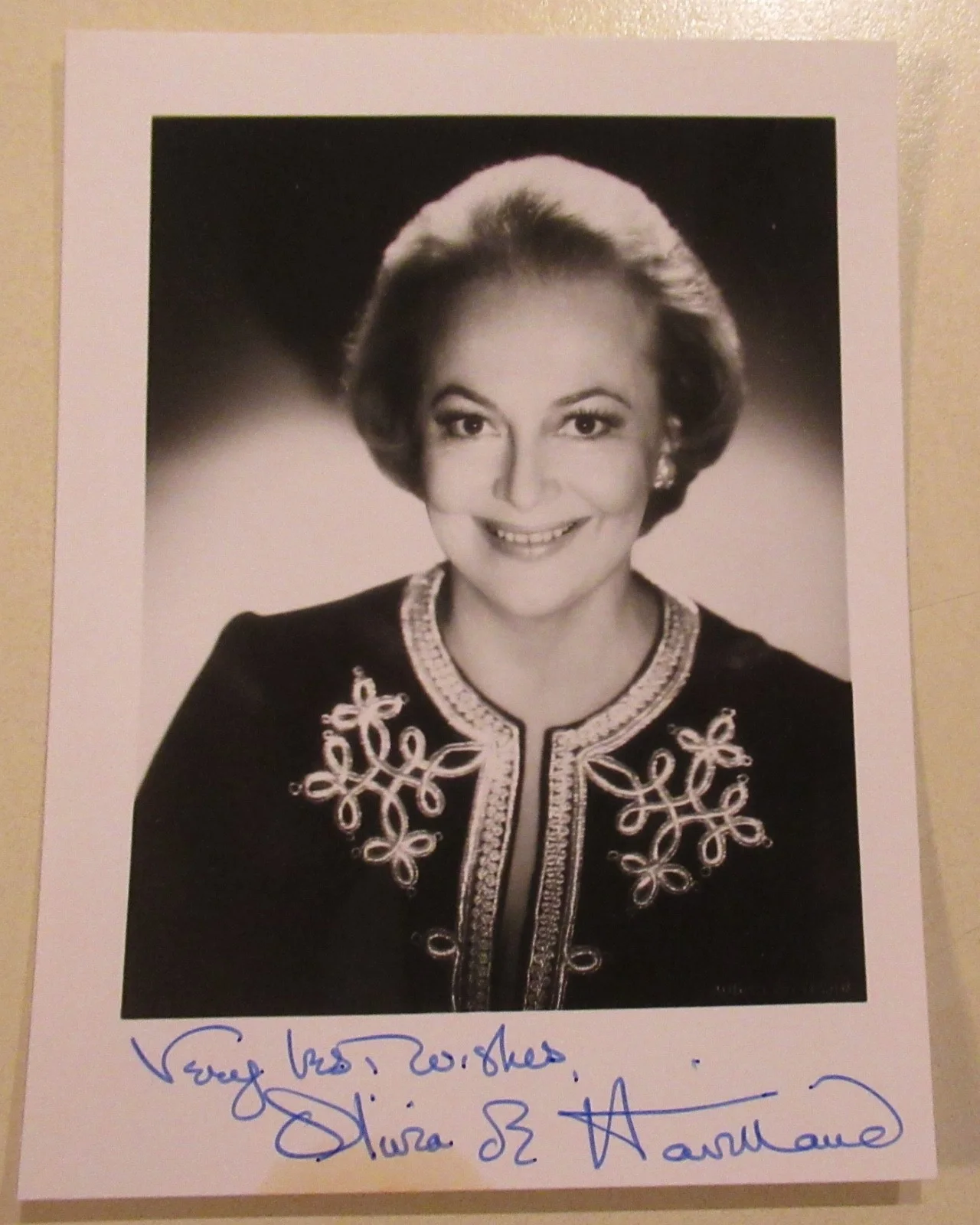 OLIVIA DE HAVILLAND — small sized signed photo of OLIVIA DE HAVILLAND from Paris signed in late 1980s