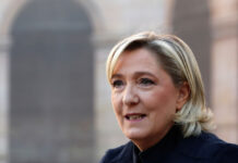 Far-right leader Marine le Pen arrives to attend a national tribute for late singer Charles Aznavour during a ceremony in Paris