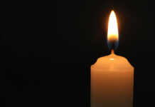 One,Burning,Church,Candle,On,Black,Background,,Closeup.,Space,For